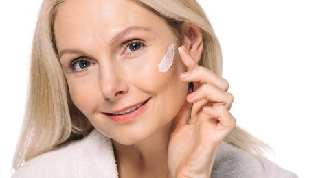 mature woman applying cosmetic cream